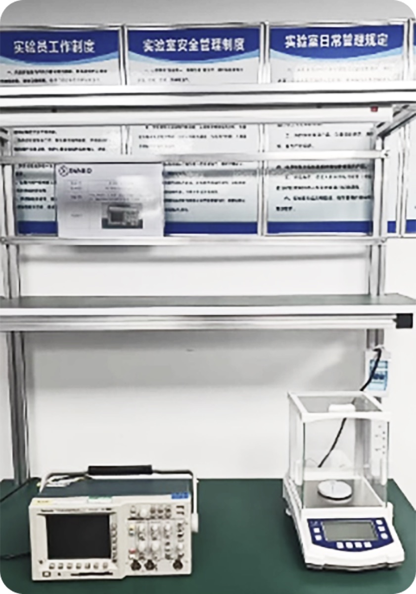 Oscilloscope and precision balance on lab workbench